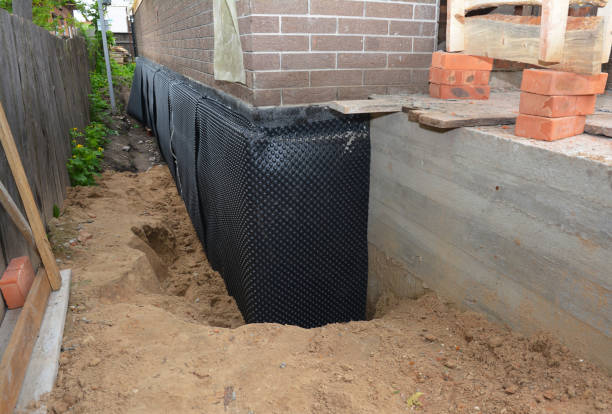 SJ Waterproofing Pros technician performing targeted Wet Basement Repair assessment in Dunbridge, OH